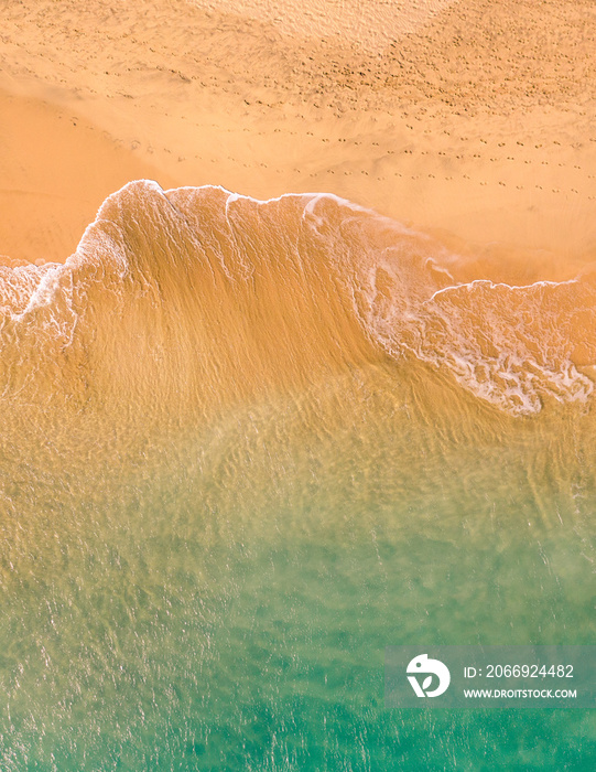 Aerial top down view of beautiful Atlantic ocean coast with crystal clear turquoise water and sandy beach