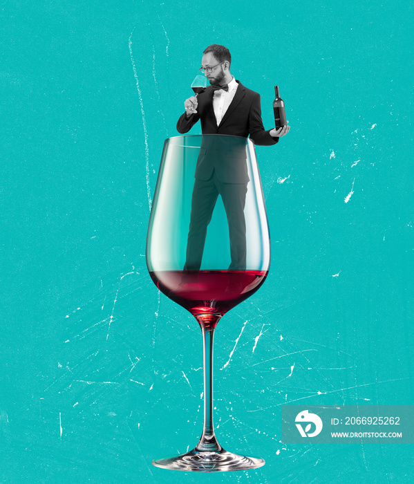 Contemporary art collage, modern design. Party mood. Young man in black suit into red wine glass isolated on blue background. Surrealism