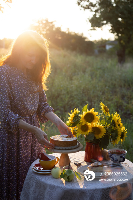 girl serving tea table in the garden