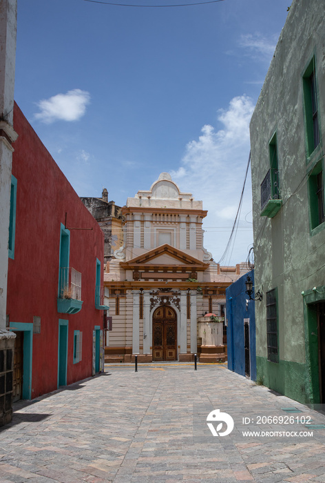 Ex-convento del Carmen en Atlixco, Puebla, Mexico, renaissance greek style convent facade in a mexican magic town at the background of a traditional colorful street