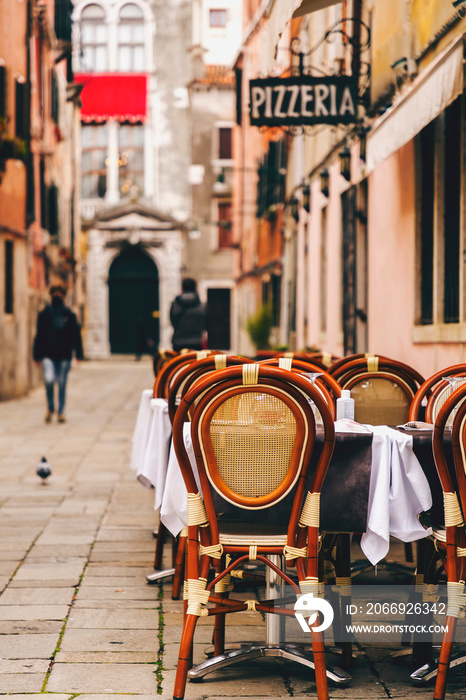 Outdoor tables at Italian trattoria and pizzeria in Venice, Italy