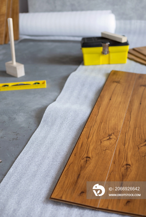 Laminate floor background texture and tools. Wooden laminate floor plank