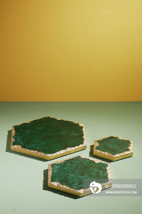 Empty Green marble pentagon tray on green table with light background