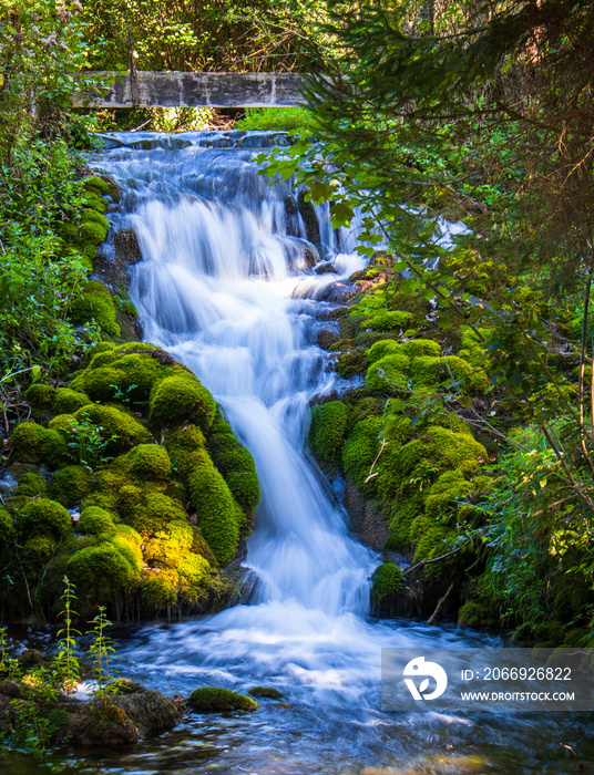 Small waterfall next to the old house in a yard in village Martin Brod in Bosnia and Herzegovina