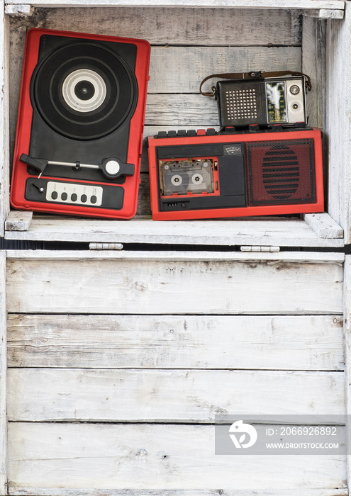 vintage audio equipment and tape recorder on white wooden background