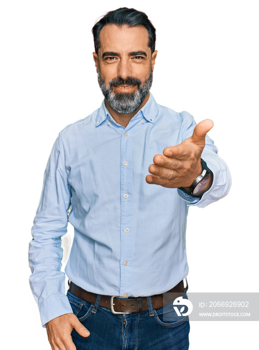 Middle aged man with beard wearing business shirt smiling cheerful offering palm hand giving assistance and acceptance.