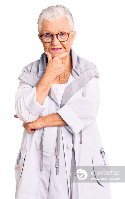 Senior beautiful woman with blue eyes and grey hair wearing casual clothes and glasses looking confident at the camera smiling with crossed arms and hand raised on chin. thinking positive.