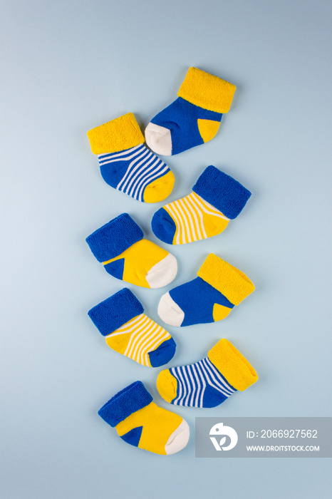 World Down Syndrome Day background. Different socks on blue background. Down syndrome awareness concept. Odd socks as symbol of Down Syndrome.