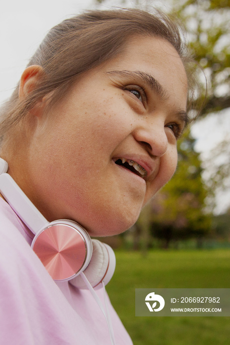 Young mid-sized woman with Down syndrome working out outdoors