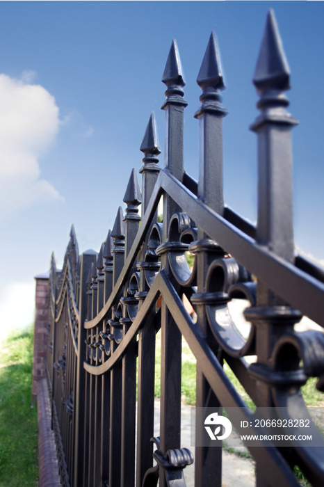 Metal fence over blue sky