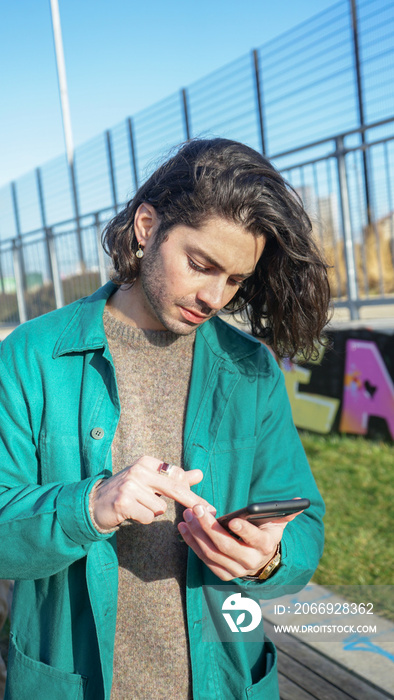 Man using smart phone outdoors