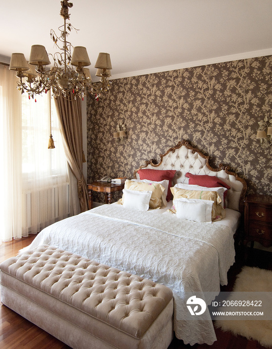 classic white and gold bedroom style with retro wallpaper and old lamp style.