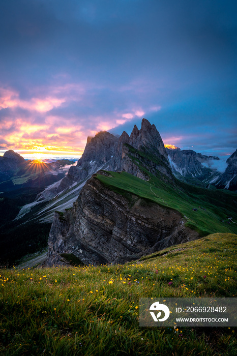Sunrise at the mountain peaks of seceda in the dolomites.