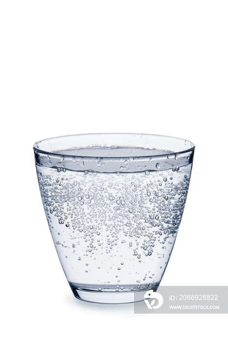 Glass of carbonated water with bubbles on white
