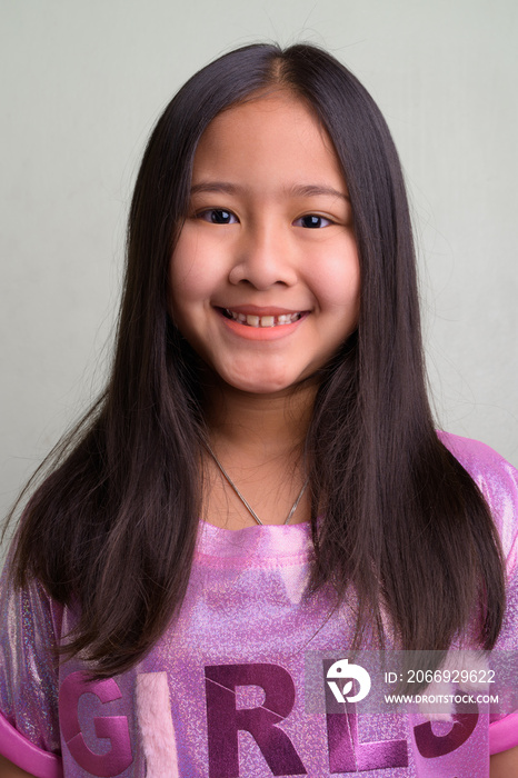 Portrait of young cute Asian girl wearing stylish clothes