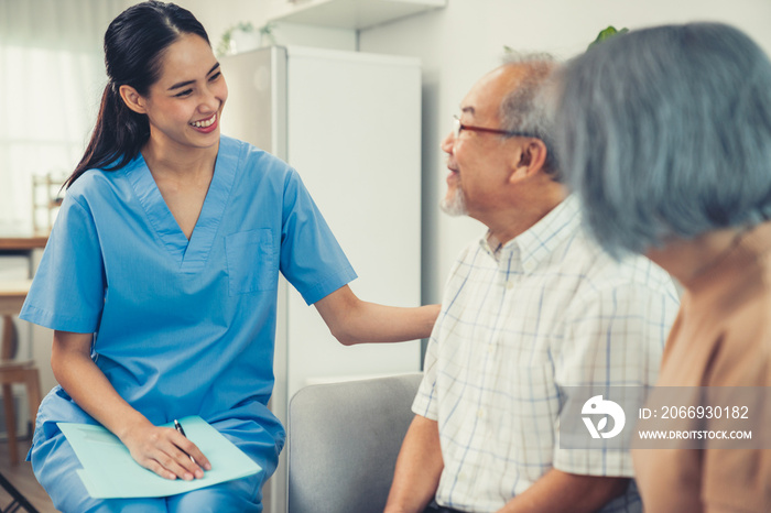 Female doctor visiting a contented elderly couple at their home. Health care, senior health support staff.