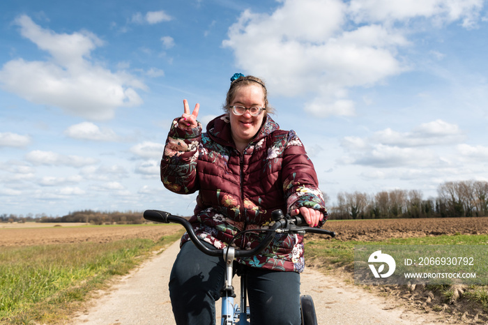 39 year old white woman with Down Syndrome driving a tricicyle