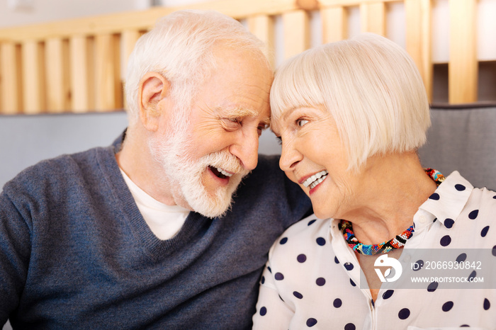 Love language. Adorable senior couple embracing and smiling