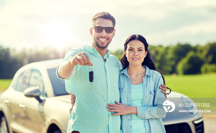 transport, road trip, travel, family and people concept - happy man and woman with car key hugging