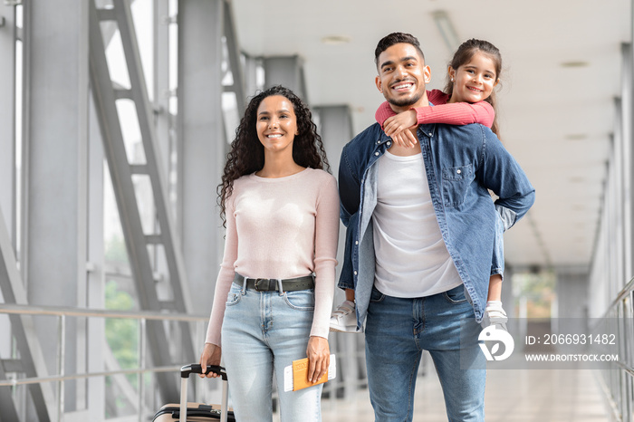 Portrait Of Happy Loving Middle Eastern Family Walking With Suitcases In Airport