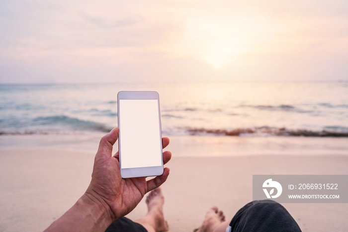 Young man traveler using  smartphone at tropical sand beach, Summer vacation concept