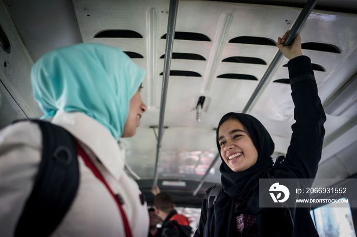 Mother and daughter riding public transport in city