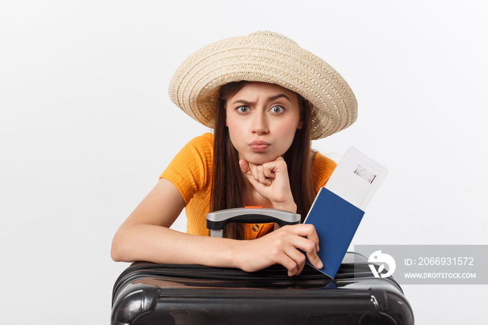 Lifestyle and travel Concept: Young beautiful caucasian woman is sitting on suitecase and waiting for her flight.Isolated over white background