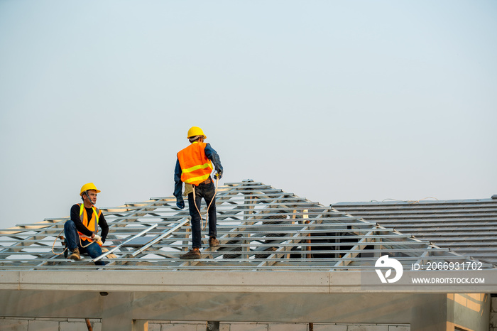 Roofer working on roof,Professional roofer are installing new roof on top roof of modern house.