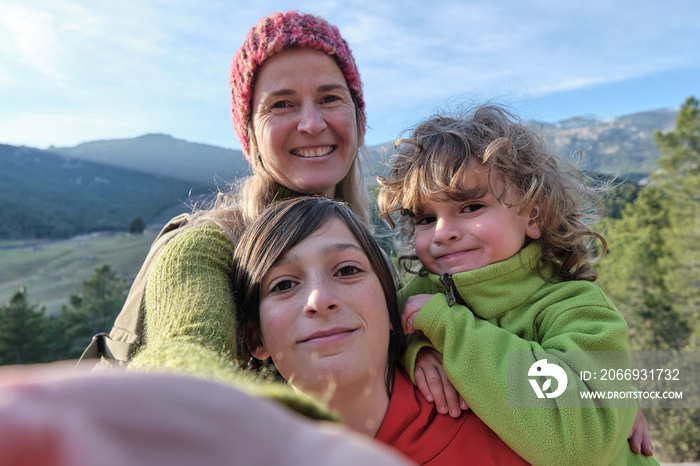 A Family making a selfie with the mountain in the background