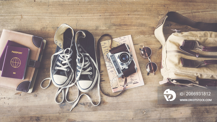 Travel concept with passport camera map bag on wooden background