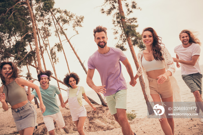 Photo of young friends happy positive smile walk run vacation weekends seaside rest nature trees outdoors