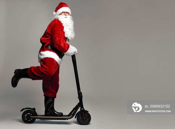 Santa Claus riding an electric scooter