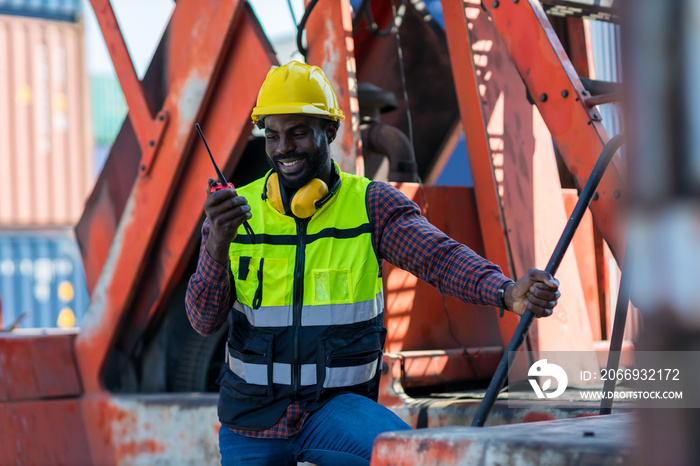 Foreman holding walkie- talkie for control working at Container cargo site. Handheld walkie talkie for outdoor