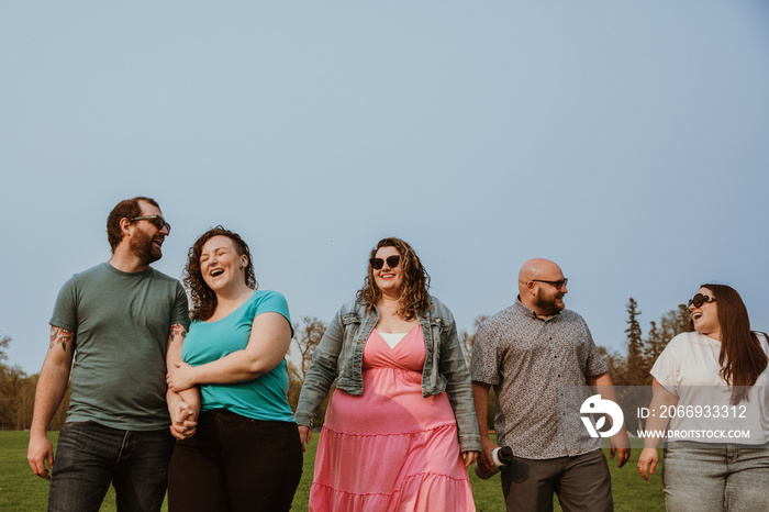 group of friends walk in the park