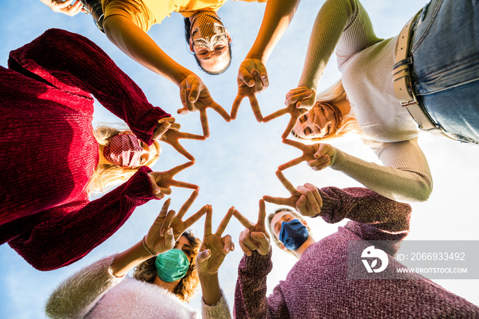 Group of young people support each other against Coronavirus - New normal lifestyle concept of friends with face mask outdoor.