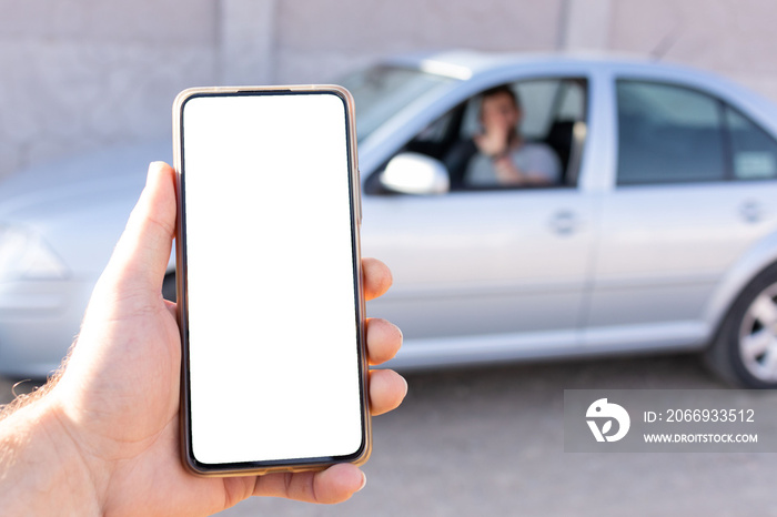 first person view of taxi app user using phone with white screen finding car blurred background, pov