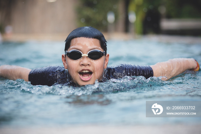 face of asian boy swimming in water sport pool