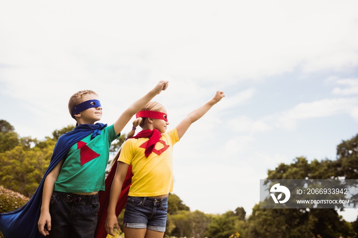 Children pretending to fly in superhero costume