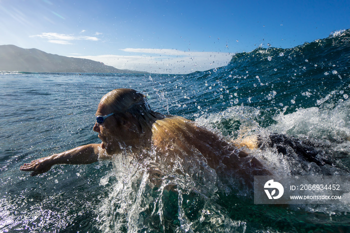 Bodysurfer swims in the waves of Mauritius