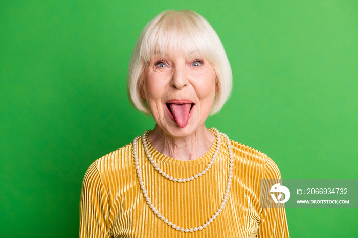 Portrait of nice optimistic short hair old lady wear yellow blouse necklace isolated on vivid green color background