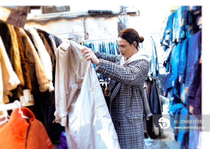 Girl looking at clothes in a flea market. The flea market. Madrid