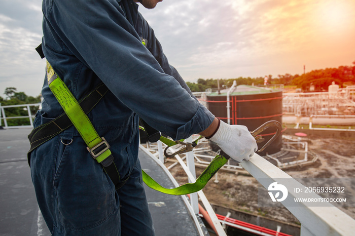 Male worker wearing safety first harness and safety lone working at high handrail