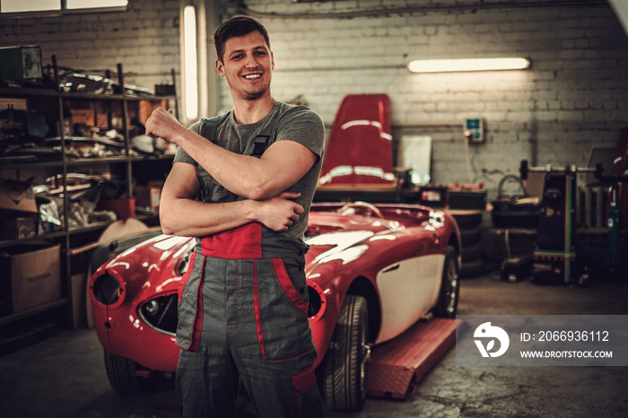 Mechanic in classic car restoration workshop