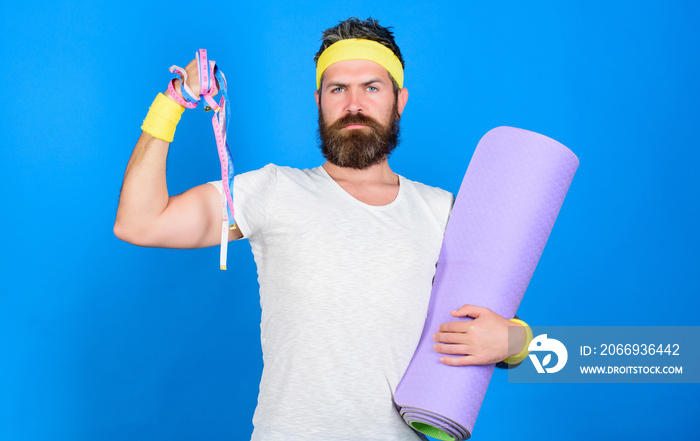Athlete guide stay in shape. Athlete professional coach motivated for training. Old school aerobics concept. Athlete wear bandages for sweat. Man bearded athlete hold fitness mat and tape measure