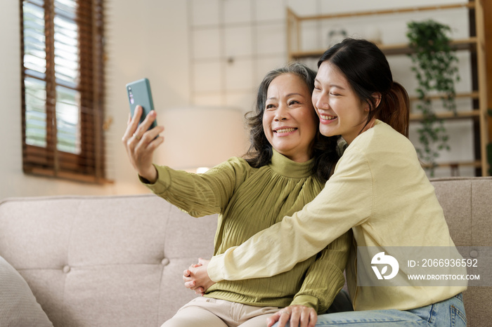 Mature asian mom with daughter on video call to parents, loving mother day concept.