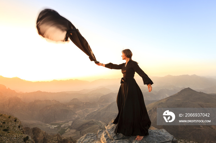 Woman with a scarf in the mountains