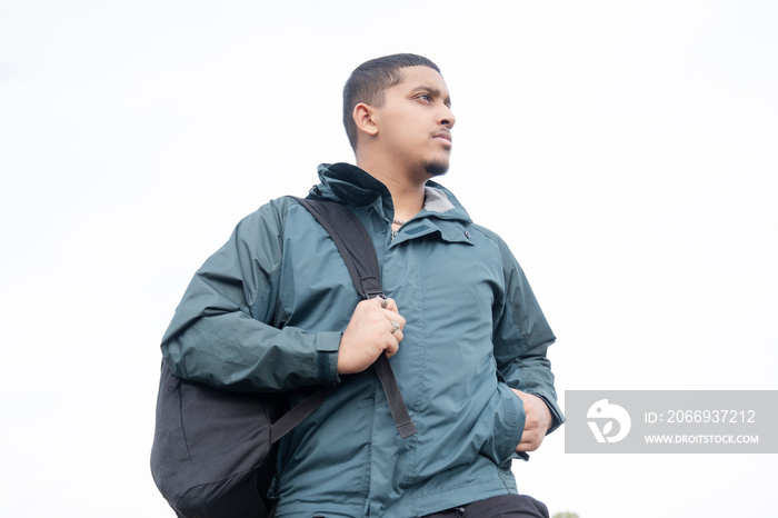 Portrait of man with backpack standing outdoors