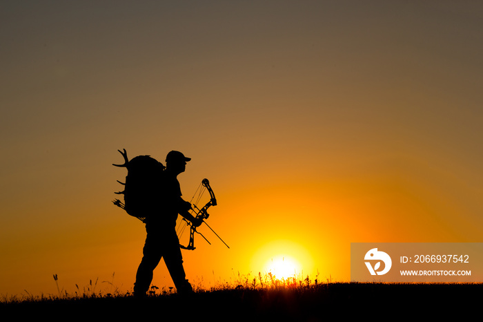 Silhouette of a bow hunter