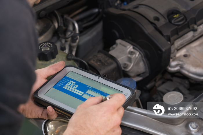 Car repair workshop, checking the interior of the engine with a workshop, annual technical inspection of the vehicle