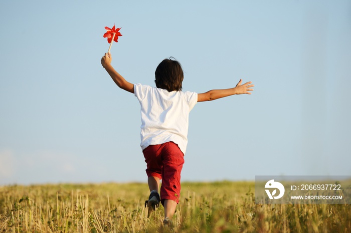 Happy kid running on beautiful field